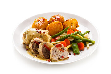 Meatballs with potatoes and vegetables on white background 