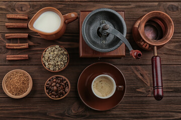 Fresh coffee with ingredients and accessories on wooden background