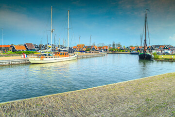 Fototapeta na wymiar Fabulous dutch fishing village with boats in harbor, Marken, Netherlands