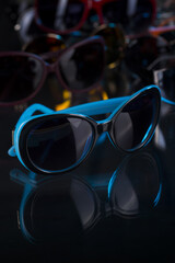 various sunglasses on a dark background