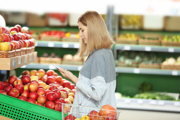 Beautiful woman buying fruits in market