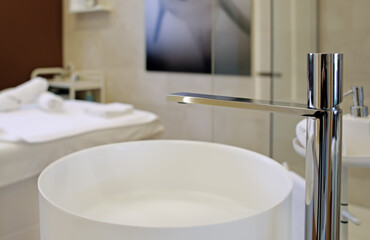 Washbasin and water faucet in spa salon