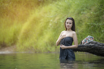 The girl was bathing brook,country girl portrait in outdoors,beautiful happy Asian girl smile and laugh together.