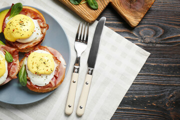 Tasty eggs Benedict on plate, top view