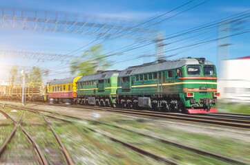 Fototapeta na wymiar Double freight train green locomotive and on the forks of the railway tracks.
