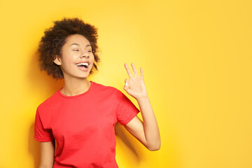 Beautiful African girl on yellow background