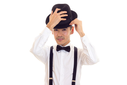 Young man with bow-tie, suspenders and hat