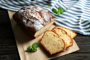 Delicious sliced yogurt cake with raisins on cutting board