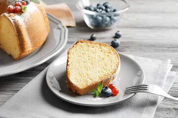 Delicious sliced yogurt cake on grey table
