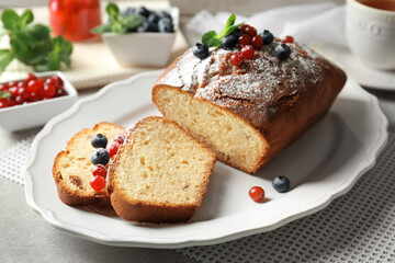 Delicious sliced yogurt cake with berries on white plate