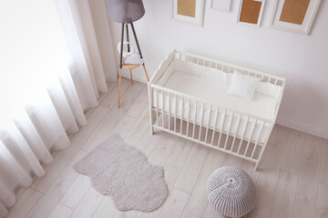 Interior of light cozy baby room with crib and bedding - obrazy, fototapety, plakaty