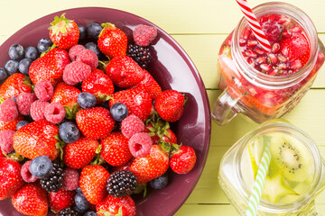 Fresh fruits flavored water in jars and mixed soft fruits