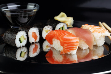 close up of sashimi sushi set with chopsticks and soy - sushi roll with salmon and sushi roll,...