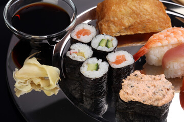 close up of sashimi sushi set with chopsticks and soy - sushi roll with salmon and sushi roll,...