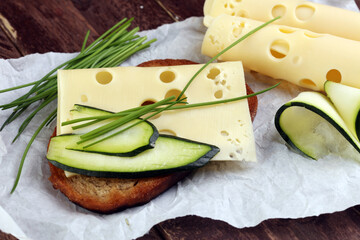 Bread with slices of cheese for lunch table. Sharing antipasti on party or summer picnic time over...