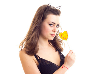 Young woman in black bra with candy