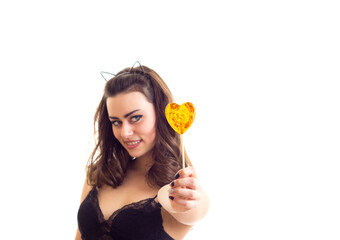 Young woman in black bra with candy