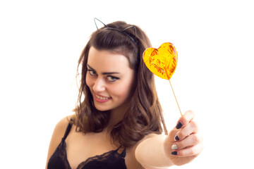 Young woman in black bra with candy