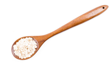 Wooden spoon with oats isolated on white background. Close-up.