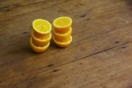 Yellow Fresh Lemon Slice Over Wooden Background