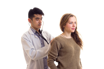 Doctor listening to woman's back