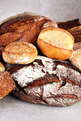 freshly baked bread. Different kinds of bread and bread rolls on board from above. Kitchen or bakery poster design.