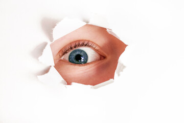 Spy eye  looking through paper hole