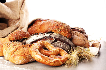 freshly baked bread. Different kinds of bread and bread rolls on board from above. Kitchen or bakery poster design.