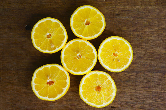 Yellow Fresh Lemon Slice Over Wooden Background
