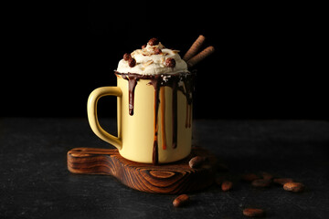 Sweet dessert with chocolate and cream on black background