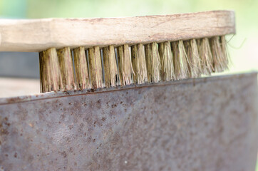 Wire brush over a rusty sheet of metal