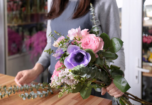 Female florist creating beautiful bouquet in flower shop