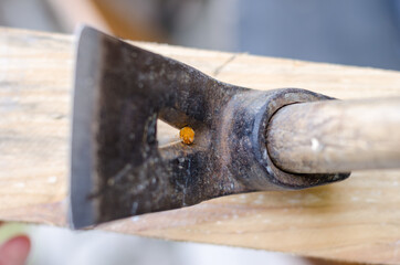 Using hammer and nail on wood and bokeh background