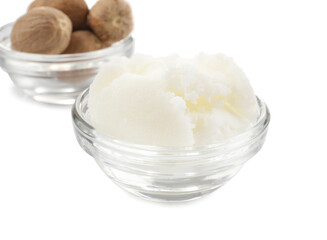 Shea butter and nuts in bowls on white background