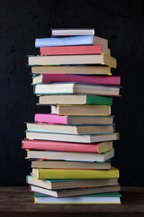 Stack of books on the background of the school Board.