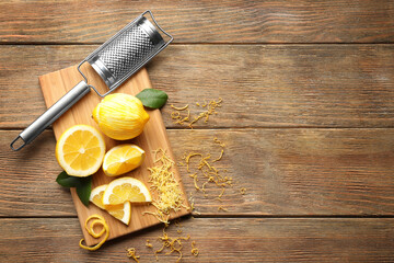 Composition with lemons and grater on wooden table