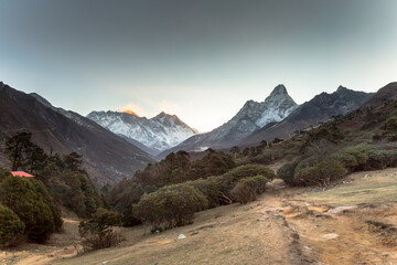 Fototapeta na wymiar Sunrise in Himalayas. Ama Dablam, Nuptse, Lhotse and Everest in first rays of sun. Two eight-thousander peaks. View from Tengboche. Sagarmatha National Park, Solukhumbu District in Nepal, Asia. 