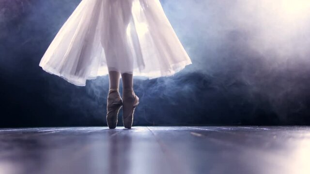 Ballerina dancing on her toes in long skirt