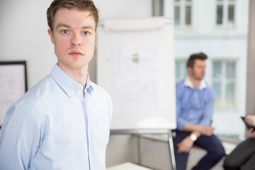 Fototapeta premium Confident Young Businessman Standing In Office