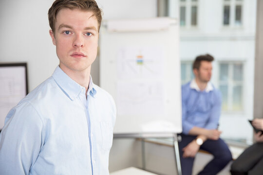Confident Young Businessman Standing In Office