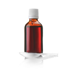 Bottle with cough syrup and measuring spoon on white background