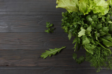 mix herbs. coriander, parsley, dill, spinach, salad on wood background. Top view with copy space