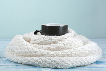 Fototapeta na wymiar Top view image of white cozy knitted sweater with to cup of coffee on a wooden table.