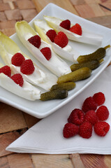 Tray with pickles, raspberries and endives 