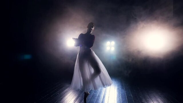 Beautiful moves of a ballet dancer in the dark