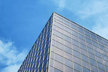 Fototapeta na wymiar Building with tinted windows against blue sky