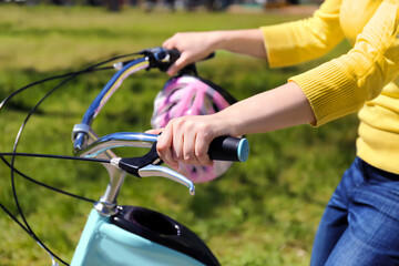 Obraz premium Young woman riding bike in park on sunny day