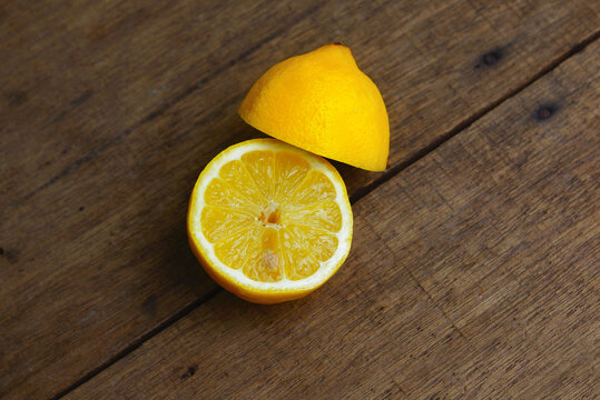 Yellow Fresh Lemon Slice Over Wooden Background