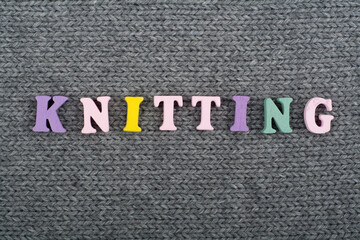 Knitting. Knitted Fabric Texture. Word composed from ABC alphabet letters.