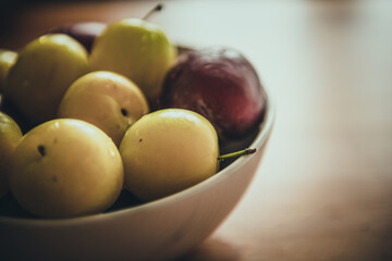 Fresh plums in bowl.